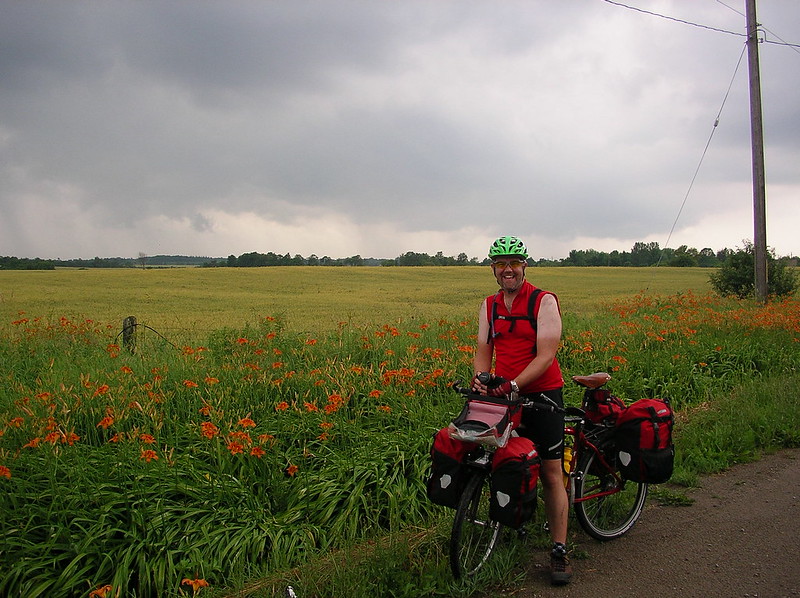 Me standing with my bike and panniers. Cycling is my preferred physical activity.